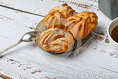Choux pastry and spoon, on wooden background. Close Choux Cream. With a metal spoon and fork on the background Stock Photo
