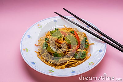 Chowmein noodles on a plate with chopsticks Stock Photo