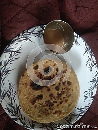 Chpati with tee on the a white plate it`s like Indian morning food Stock Photo
