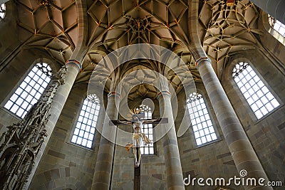 Christ Crucified and vertical view to Gothic chor vault of Saint Michaels Church, Schwabisch Hall, Baden-Wurttemberg, Germany Stock Photo