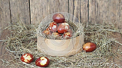 Christ is risen. Onion-painted eggs on dried grass in a nest. Traditional spring festive orthodox food. Easter Sunday Stock Photo