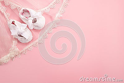 Christening background with baptism baby shoes on pink background Stock Photo