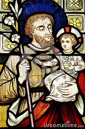 Colored stained leadlight church window Joseph holding baby Christ Jesus Stock Photo