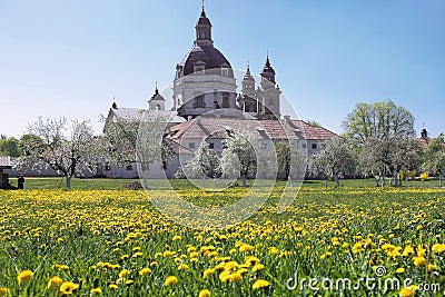 Christian baroque monastery in blooming spring meadow. Stock Photo