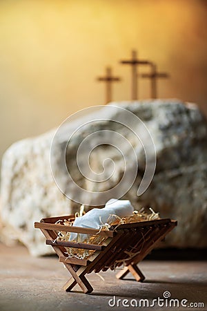 Christian Christmas, Easter concept. Born to Die, Born to Rise. Wooden manger, three crosses background. Jesus - reason Stock Photo