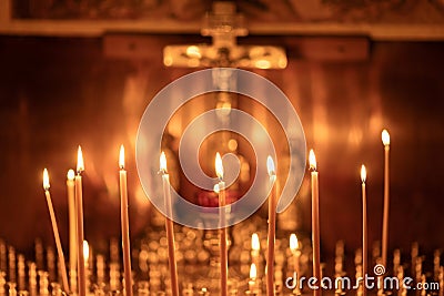 Christian church, wax candles burn before the crucifixion of Jesus Christ, faith in eternal life, prayer background, soft focus Stock Photo