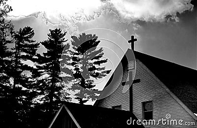 Christian cross against an ominous grey sky Stock Photo