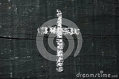 Christian cross on a dark gray wooden surface Stock Photo