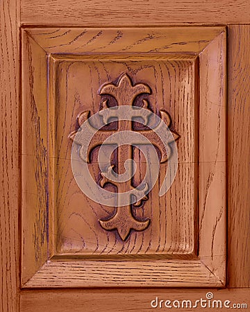 Christian cross etched in wooden door panel Stock Photo