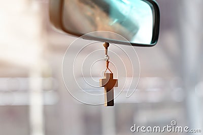 Christian cross hangs on the mirror in the car Stock Photo