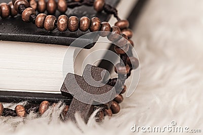Christian cross necklace on Holy Bible book, Jesus religion concept as good friday or easter festival Stock Photo