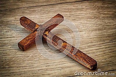 Christian Cross - symbol of the Christian faith, the main attribute of Christians. Handmade wooden cross on wooden background Stock Photo