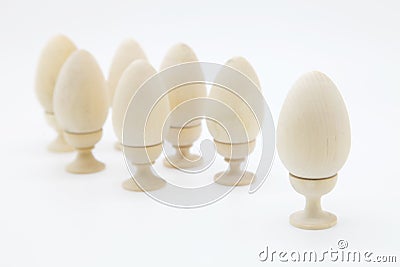 Christian Easter.One egg stands in front of all.Many wooden eggs for coloring stand on stands. Stock Photo