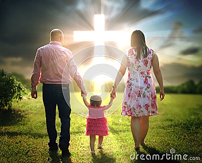 Christian family walks to cross Stock Photo