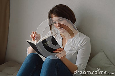 The Christian holds the Bible in his hands. Stock Photo