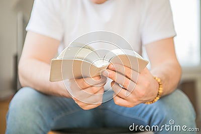 The Christian holds the Bible in his hands. Reading the bible. The concept of faith, spirituality and religion Stock Photo