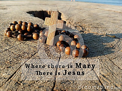 Christian inspirational quote - Where there is Mary, there is Jesus. With wooden Rosary with Jesus Christ holy cross crucifix. Stock Photo