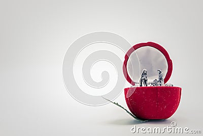 Christian nativity scene on a red rose flower. Left copy space. Stock Photo