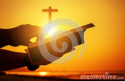 Christian praise on hill thanksgiving day background. Christian man or woman hands holding and reading a bible holy. Hands folded Stock Photo