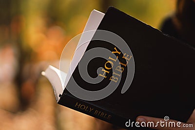 Christian teen girl holds bible in her hands. Reading the Holy Bible. Concept for faith Stock Photo