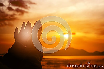 Christian woman praying worship at sunset. Hands folded in prayer. worship god with christian concept religion. Stock Photo