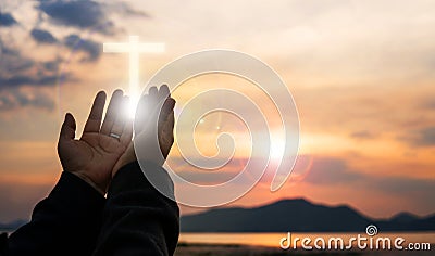 Christian woman praying worship at sunset. Hands folded in prayer. worship god with christian concept religion. Stock Photo