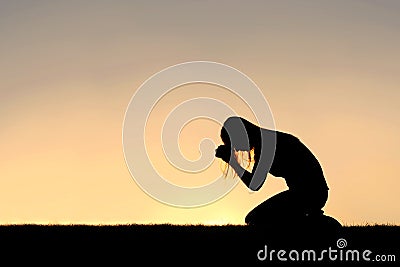 Christian Woman Sitting Down in Prayer Silhouette Stock Photo
