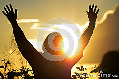 Christian woman worships & praises God hoping for answered prayer Stock Photo