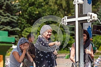 Christian women in traditional head scarfs near the Holy spring Editorial Stock Photo