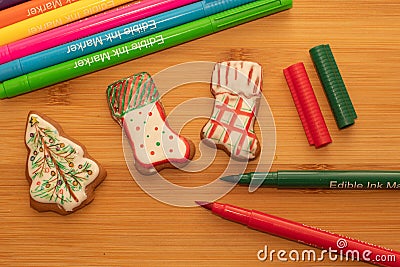 Christmas activities with kids. Decorating christmas gingerbread cookies with edible ink pen markers Stock Photo