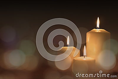 Christmas advent candle light in church with blurry golden bokeh for religious ritual or spiritual zen meditation, peaceful mind Stock Photo