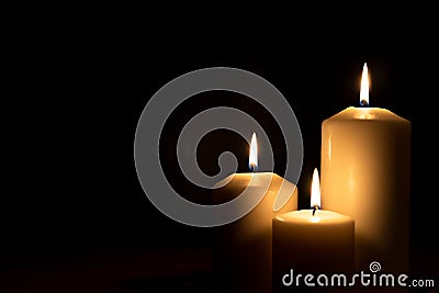 Christmas advent candle light in church with blurry golden bokeh for religious ritual, spiritual zen meditation, peaceful mind Stock Photo