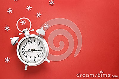 Christmas alarm clock with snowflakes and copy space on red bac Stock Photo