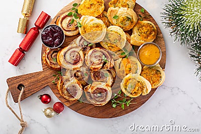 Christmas appetizers, puff pastry wheels filled with cheese and jam Stock Photo