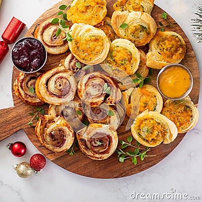 Christmas appetizers, puff pastry wheels filled with cheese and jam Stock Photo