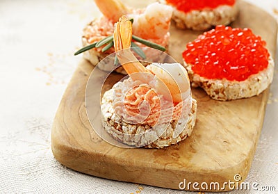 Christmas appetizers. Small tartlets with caviar and pate. Stock Photo