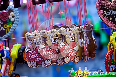 Christmas atmosphere of the city at night. Christmas sweets. Gingerbread-bears. Gingerbread-heart. Caramel rolls.. Christmas Fair Stock Photo