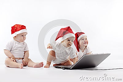 Christmas babies with laptop Stock Photo