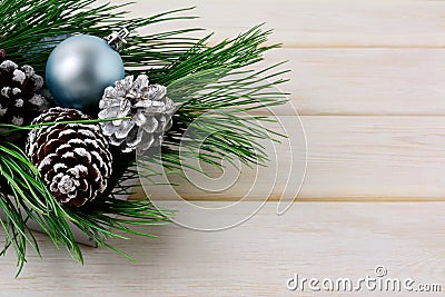 Christmas background with blue ornaments, silver and snowy pinecones Stock Photo