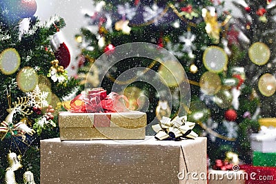 Boxes of christmas or new years gifts with christmas tree and ornaments with snowing Stock Photo