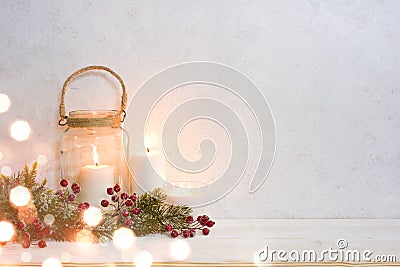 Christmas background, burning lantern candles decorated with frosted fir branches Stock Photo