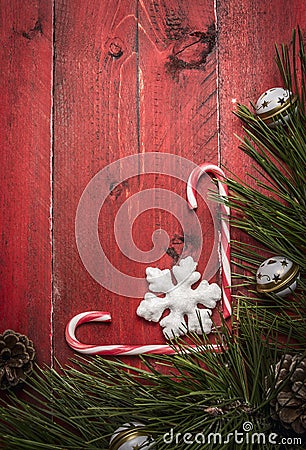 Christmas background with candy pine branches and pine cone, decorations on red wooden rustic background top view Stock Photo