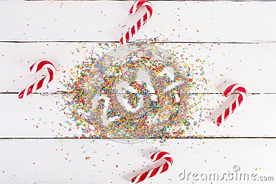 Christmas background. Christmas canes on a white wooden background. 2017 written with Color sprinkling Stock Photo