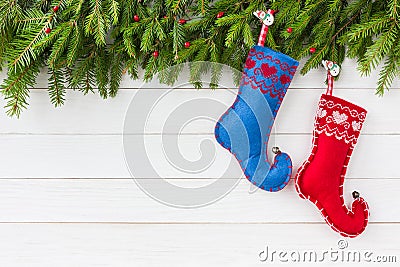 Christmas background. Christmas fir tree with decoration, red and blue Christmas socks on white wooden background, copy Stock Photo