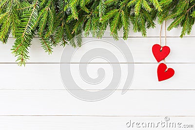 Christmas background. Christmas fir tree, red hearts decoration on white wooden background with copy space Stock Photo