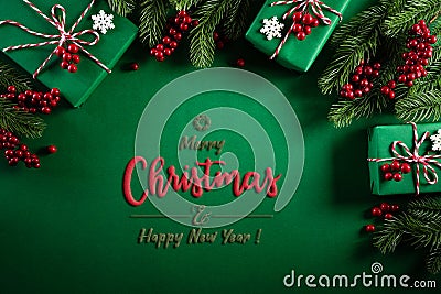 Christmas background concept. Top view of Christmas green gift box with decoration, spruce branches and red berries on green Stock Photo