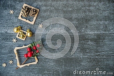 Christmas background with decorative composition of wooden frame, pine cone and snowflakes on wooden board. Happy new year. Card. Stock Photo