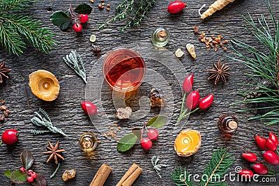 Christmas background with essential oil bottles, frankincense, myrrh, wintergreen and Christmas spices Stock Photo