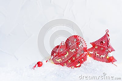 Christmas background - festive red baubles - heart and star with deers print and glow lights inside in shiny white snow. Stock Photo