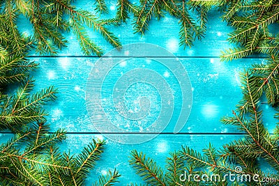 Christmas background. Christmas fir tree branches with snow on blue rustic wooden board with copy space Stock Photo